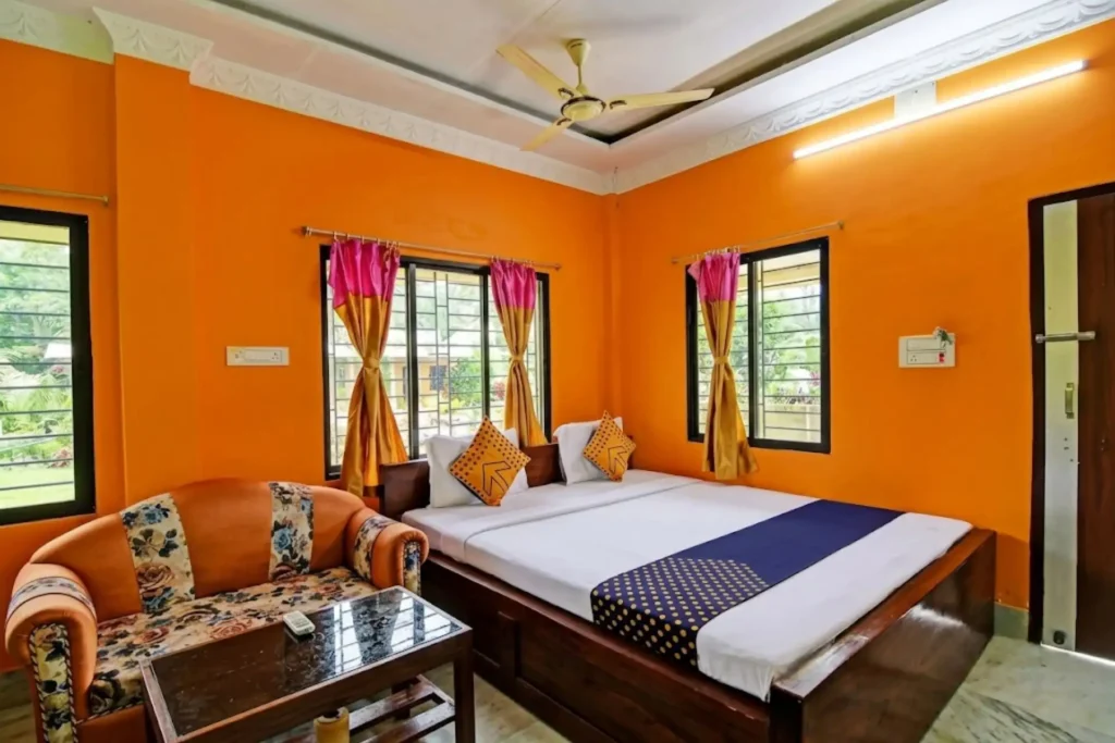 Clean deluxe hotel room with sofa seating area during Sundarban Hilsa Festival tour